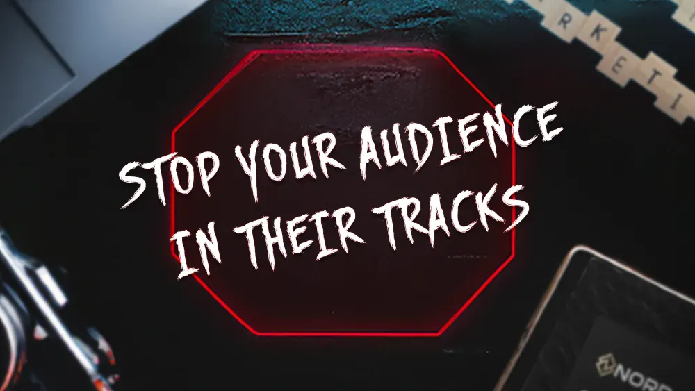 A dark-themed image with a red octagon outline in the center, containing the bold, white text "STOP YOUR AUDIENCE IN THEIR TRACKS." Surrounding the octagon are elements of digital marketing tools, including a camera and a smartphone.